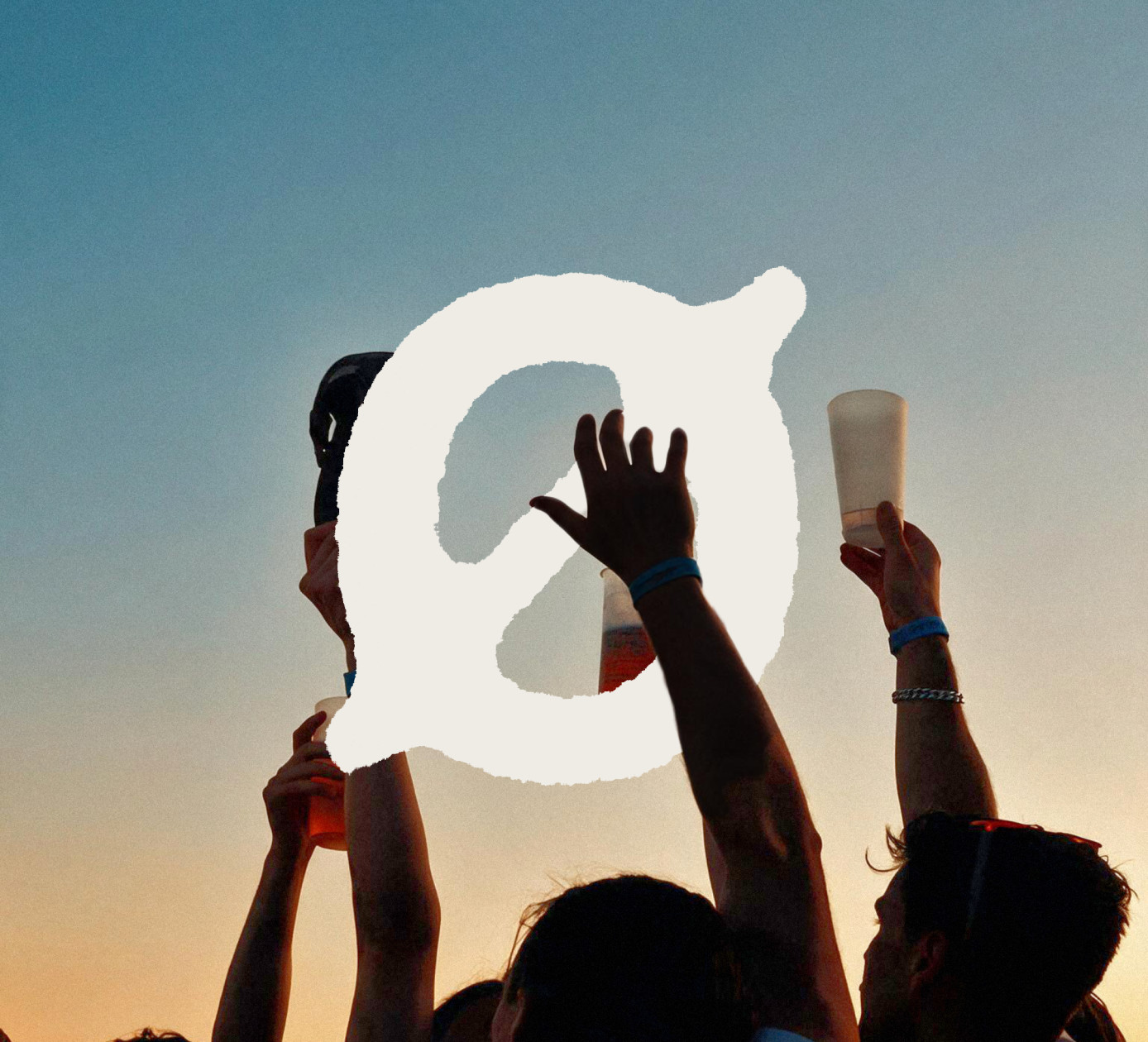 The mark held up over the crowd against a sunrise